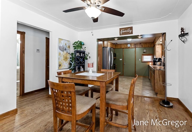 dining room featuring ceiling fan, light hardwood / wood-style flooring, and sink