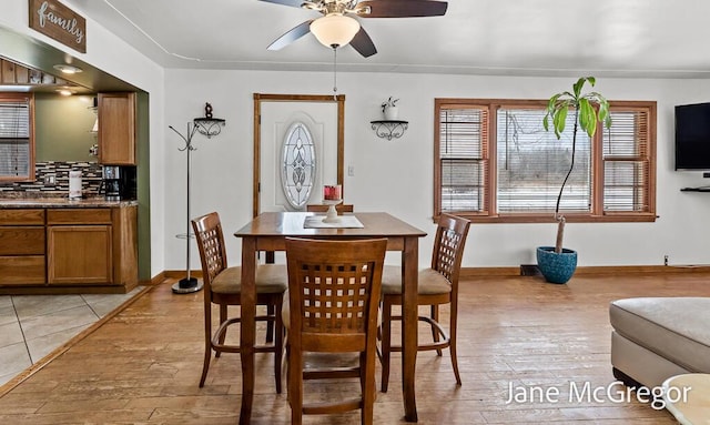 dining room with ceiling fan and light hardwood / wood-style flooring