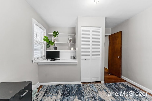 unfurnished office with dark wood-type flooring