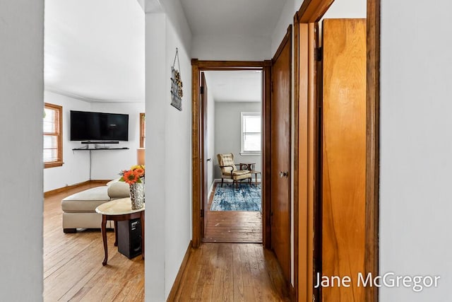 hallway with light hardwood / wood-style flooring