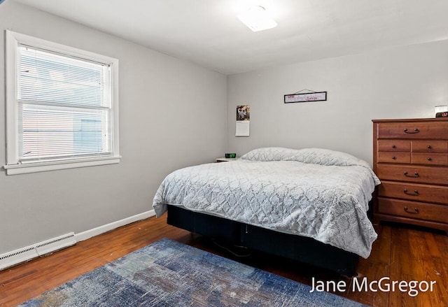 bedroom featuring hardwood / wood-style floors and a baseboard radiator