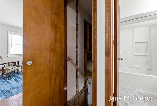 corridor with hardwood / wood-style flooring