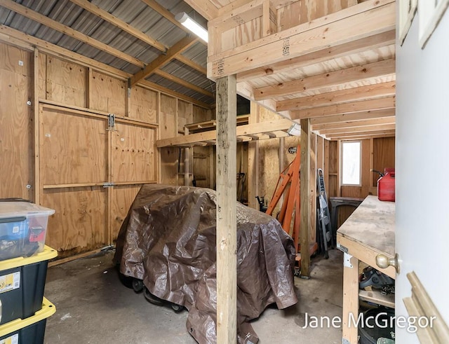 miscellaneous room featuring wood walls