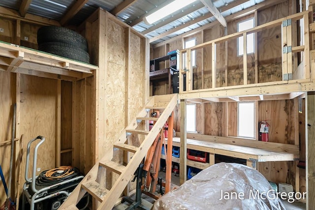 miscellaneous room with wood walls and a workshop area