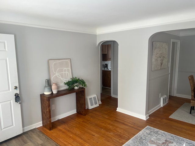 hall featuring crown molding and hardwood / wood-style floors