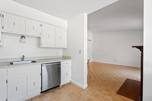 kitchen with white cabinets, light parquet flooring, dishwasher, and sink