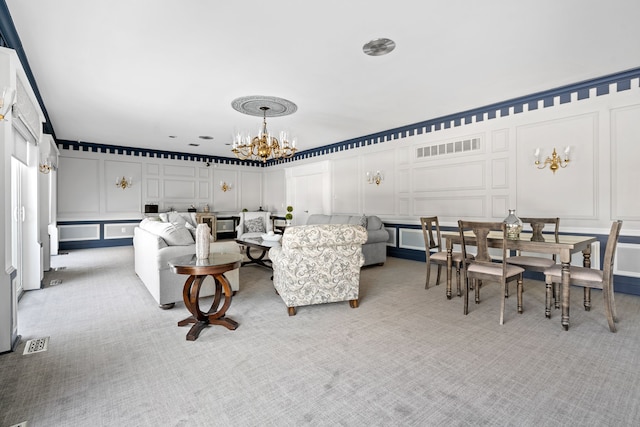 living room with light colored carpet and a chandelier