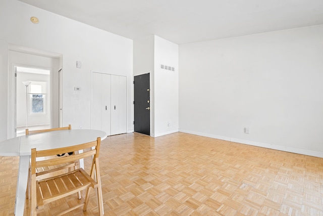 dining space with light parquet floors