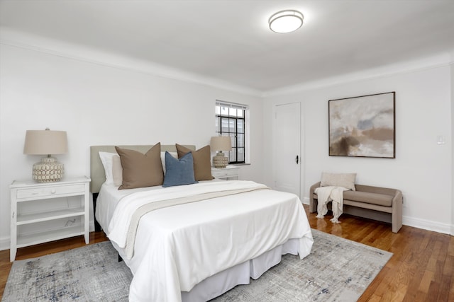 bedroom with wood-type flooring