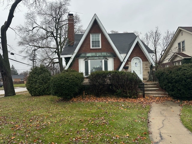 tudor house featuring a front yard