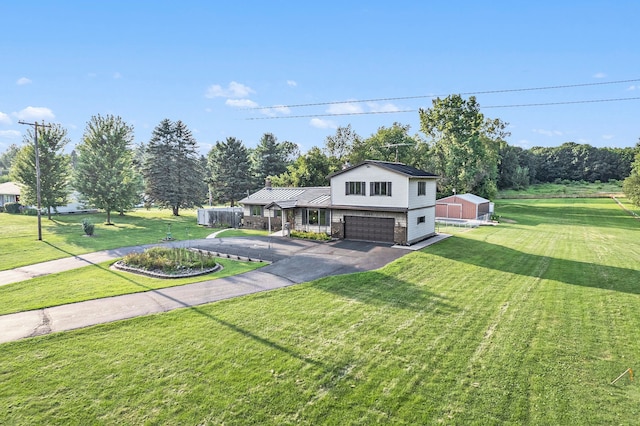 view of front facade with a front yard and a garage