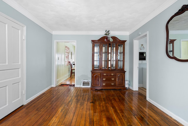 unfurnished dining area featuring ornamental molding and dark hardwood / wood-style floors