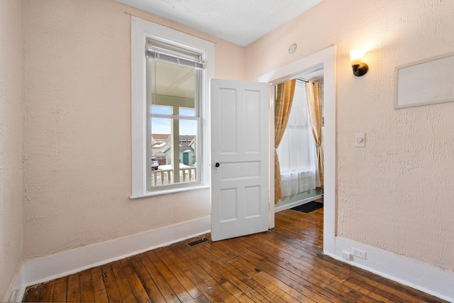 spare room with dark wood-type flooring