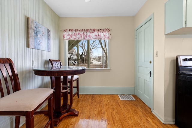 dining space featuring washer / clothes dryer and light wood-type flooring