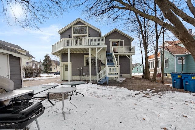 snow covered property with a balcony