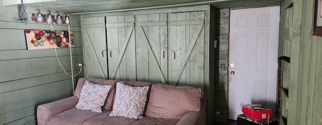 sitting room featuring wood walls