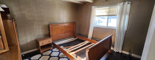 bedroom with wood walls