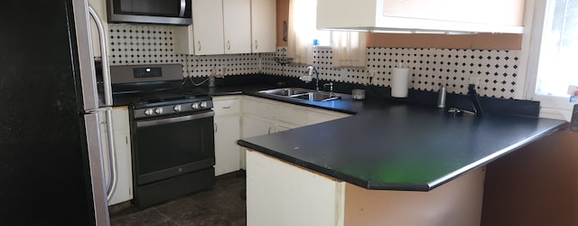 kitchen with plenty of natural light, sink, white cabinetry, and stainless steel appliances