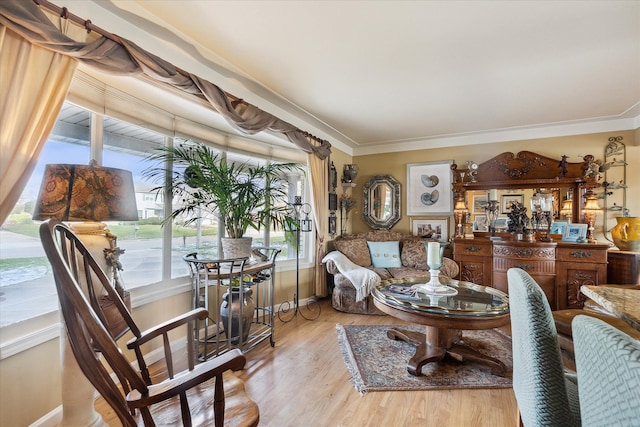 living room with light hardwood / wood-style flooring and crown molding