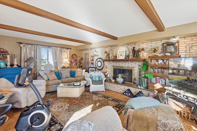 living room with a brick fireplace, brick wall, and beam ceiling