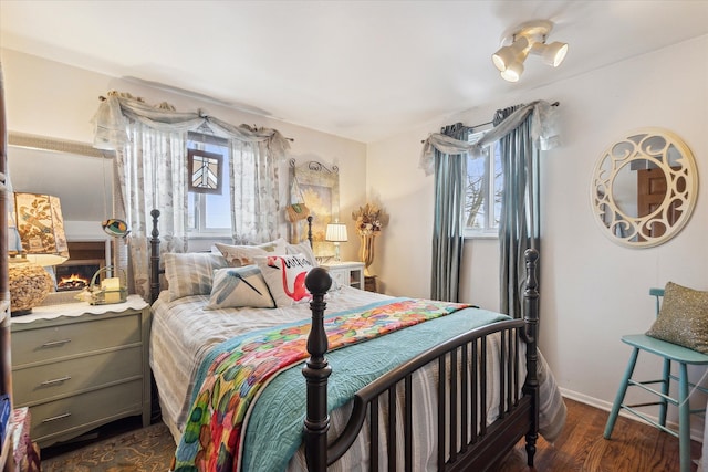 bedroom with dark wood-type flooring