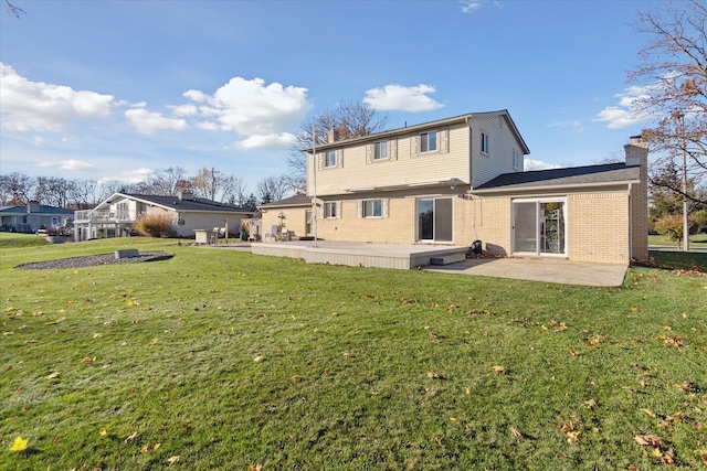 back of property featuring a lawn and a patio area