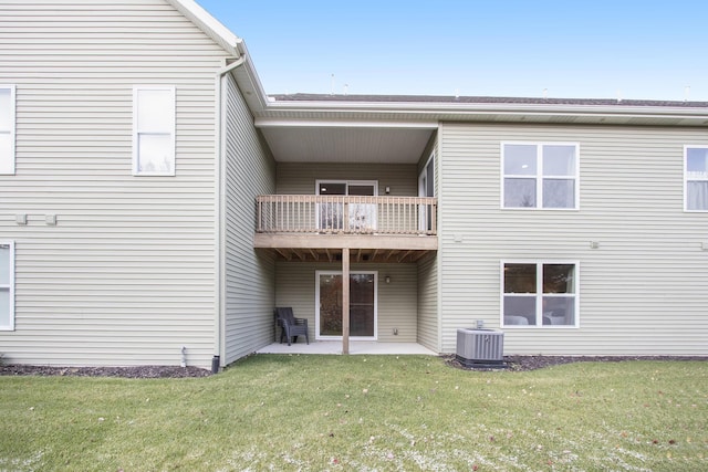 rear view of house with a yard, a patio area, and central AC