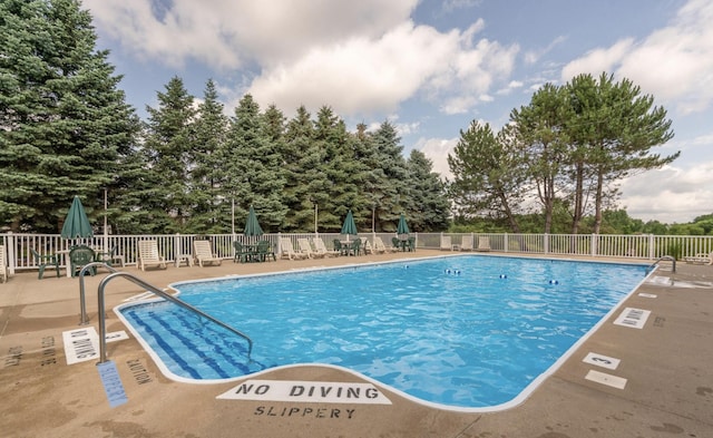 view of swimming pool with a patio