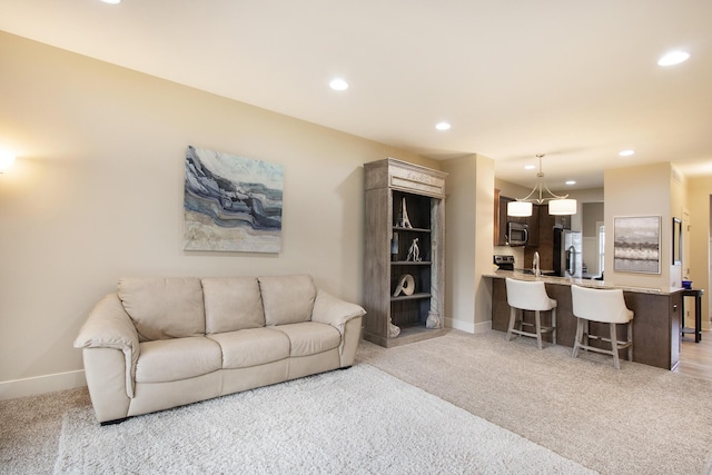 carpeted living room with sink