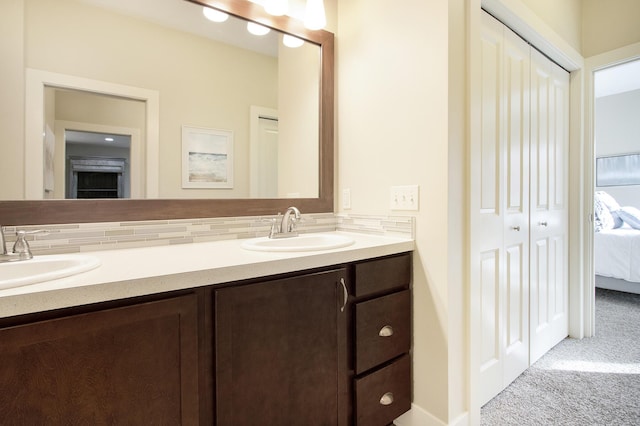 bathroom featuring vanity and tasteful backsplash