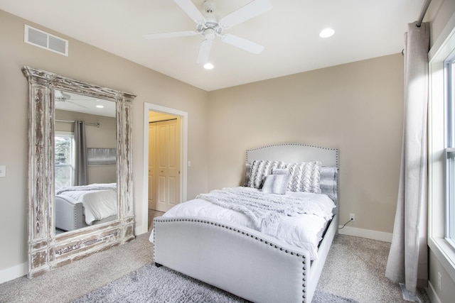 carpeted bedroom featuring ceiling fan and a closet