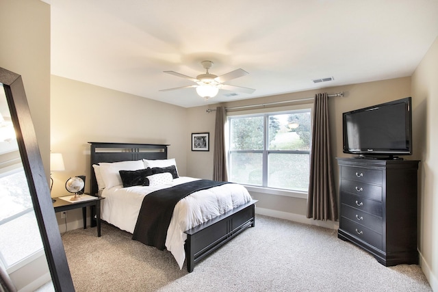 bedroom featuring ceiling fan and light carpet