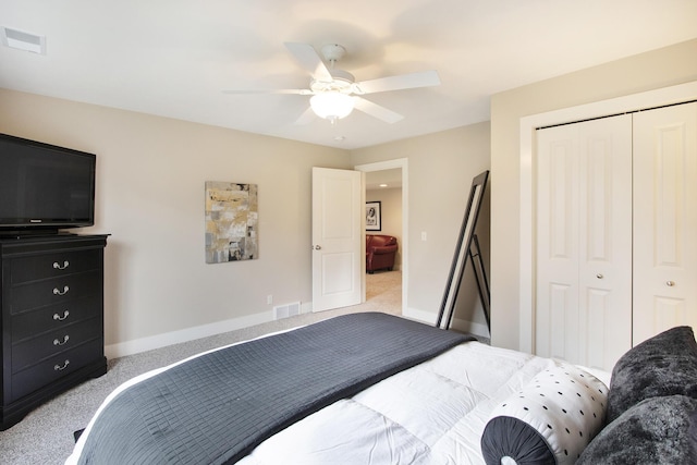 carpeted bedroom with a closet and ceiling fan