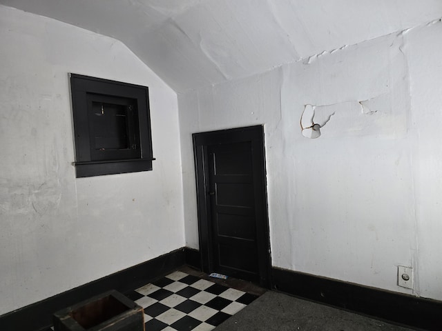 unfurnished room featuring vaulted ceiling