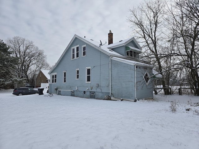 view of snow covered rear of property