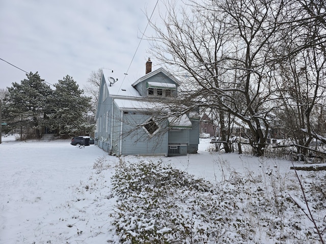 view of snow covered back of property