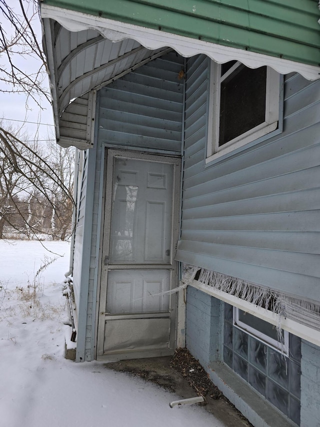 view of snow covered property entrance