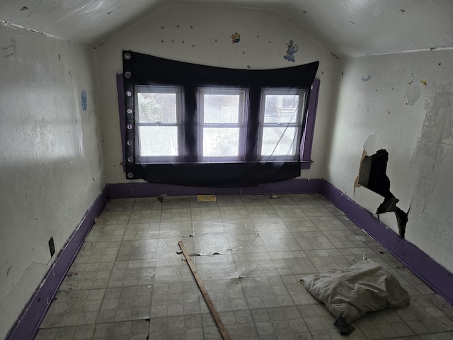 empty room featuring lofted ceiling