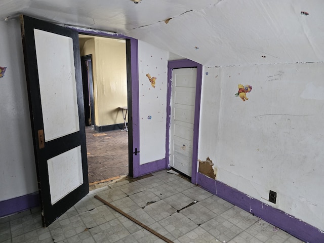 empty room with lofted ceiling and french doors