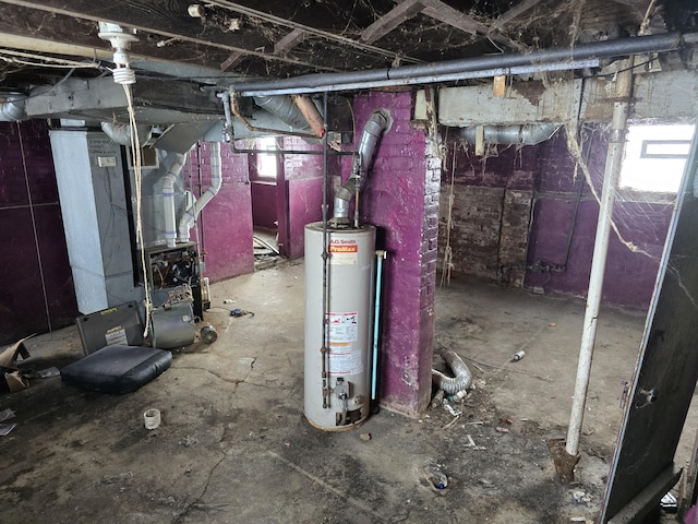 basement with heating unit, a healthy amount of sunlight, and water heater