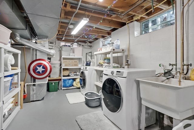 clothes washing area with washer and dryer and sink