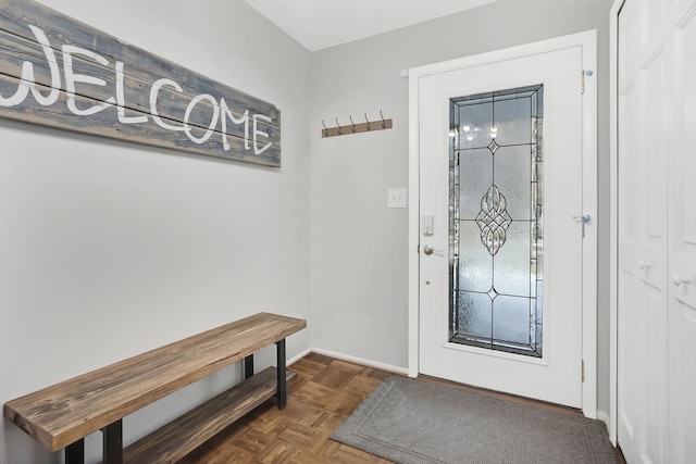 entryway featuring dark parquet flooring