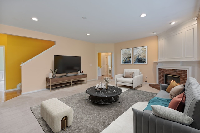 carpeted living room featuring a brick fireplace