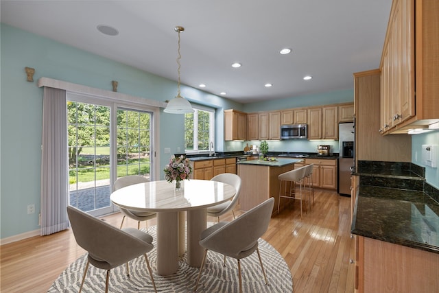 dining space featuring sink and light hardwood / wood-style floors