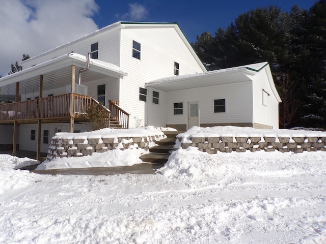 view of snow covered rear of property