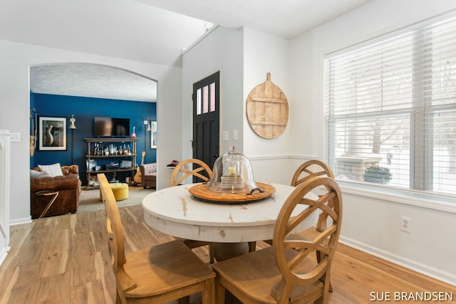 dining room with a wealth of natural light and light hardwood / wood-style floors