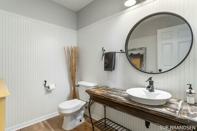 bathroom featuring hardwood / wood-style flooring, sink, and toilet