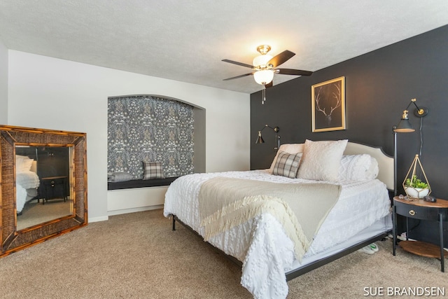 bedroom featuring ceiling fan, carpet, and a textured ceiling