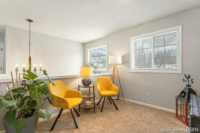 living area featuring carpet floors and an inviting chandelier