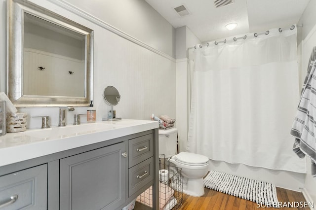 full bathroom with toilet, vanity, shower / bath combination with curtain, and hardwood / wood-style flooring